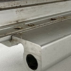 These machine screws should really be flush so I can compress the butyl tape without the frame bottoming out so I carefully filed 
them down.