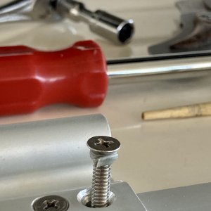 On the left is one of the two machine screws that hold the hinges