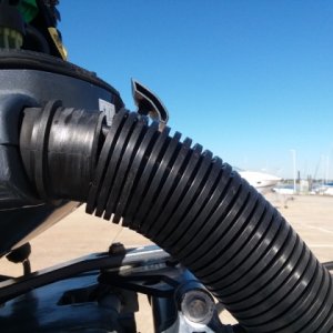 After cutting off Lowrance adapter plug, snaking wire through transom side of rigging tube and the split gasket where it enters engine. Re-connected white and blue wires to plug with 3M microdot connectors and plugged into white Yamaha plug under gas filter.