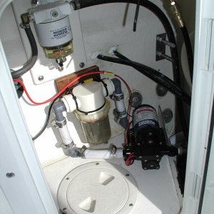 Raw water wash down pump and filter installed in Port Lazarette hatch.