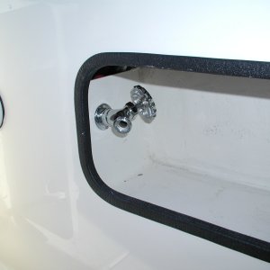 Media 'Faucet for raw water wash down installed in Port cockpit wall compartment.' in album 'Sooner or later, we'll be towing something or someone.  A Wichard towing eye to R. of Dive Ladder bracket. Sailboat gear but very heavy duty.'
