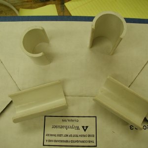1.25" ID PVC pipe, 3/8 of diameter is cut away on table saw.  Edges rounded off to protect towels, etc.