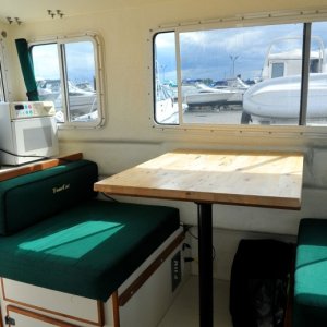 Maple Table is 2 inches longer than original table.  This still drops down for table purposes.

The seats both slide out toward the center isle to allow better seating for the occupants.