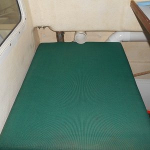 I used simple thin wall PVC for ducts.  One exits here.  The other moves cold air forward to the V-berth.