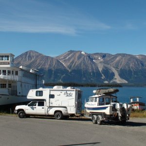 Us parked by old lake boat in town of Atlin.