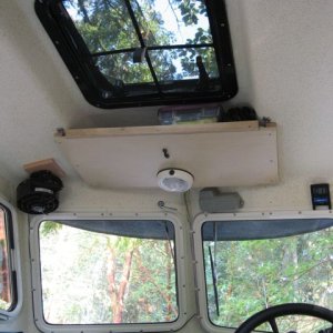 Overhead hatch with screen-- storage shelf forward. Red LED strip (less harsh for night use) installed to interior light circuit and OEM interior light moved forward (uses switch on light casing).