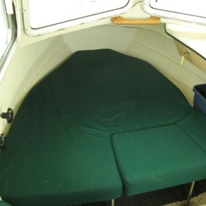 Foam cut back to provide bin storage under dash. Teak handle angled and glued to assist entry & exit from berth