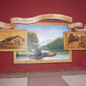 A mural on a store wall Middleport was nice home of the Basket Factory rest. Yum.Has close by laundrymat, good breakfast joint, gas not too far away. Canal facilities right next Police station very safe place. Shore power, water nice picnic benches on grassy area. Liked it here. Showers were so so.