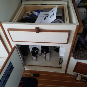 The cabinet previously used for the water heater. You can also see the teak cabinet access door I installed under the settee table.