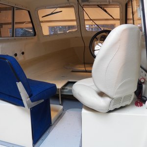 The width of the original seat hit the throttle at the bottom and the back of the seat hit the cabin side.  Also, although the original seat was shorter, the back thickness and angle interfered with the wheel when turned 180, requiring the seat to be more upright if turned around.