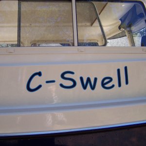 Media 'New C-Swell boat name decal' in album 'C-Swell did not have a table so I decided to add a Garelick stowable table. I added cherry wood molding made by my Dad to keep things from sliding off and to go with the other wood trim in the cabin.'