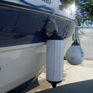 "Docking" fender configuration.  Round fender clipped to bow eye mounted as far forward as can be reached through helm window.
