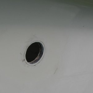 Original hole for 3/4" through-hull that connects to sink drain, marked for enlarging to fit 1" through-hull.