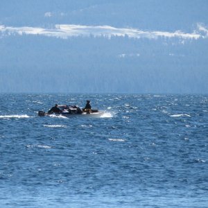 Photo by Kevin.  A couple out on the lake testing their luck on a very heavy loaded open 16 footer.  No life jackets to be seen.