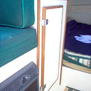 New forward port side cabinet, replaces the reversable seat.