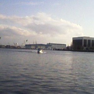 Little Tug steaming north with the Norfolk Naval Shipyard in the background