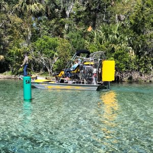 Airboat with kid spearfishing on front in Silver Glen Springs