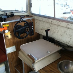 Media 'Helm with seat folded; manual sink. Port-a-potti is visible in lower left corner of the photo.' in album 'Tied up at the public dock in Port Orchard.'