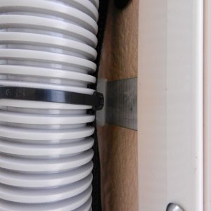 Here is what I used to keep the wiring (and Airhead vent hose) in the corner.  I made some aluminum tabs with tie-wrap anchors on the end.  I just pinched a few of these in the window frame - no holes!!