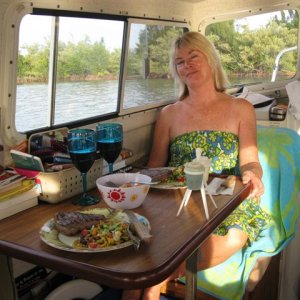 (020 20) 1st Mate Toby getting ready to enjoy supper in cool comfort.  Roughing it?