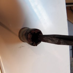 Media 'Then you tap it out and into the splash well.  Both of the drains had a skim coat of caulking and there was no balsa damage.' in album 'I removed all the fittings from the deck and transom as part of my balsa core repairs.  This is just to show how I removed the splash well brass through hull fittings to check for rot.  I used a cold chisel to tap the lip in.  First, at 90 degrees around the edge to form a four leaf clover, then an eight petal flower, etc., until the lip is pushed inside of the hole.'