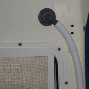 Vent through hull for potti has a chrome "look" exterior tucked up under the roof overhang.