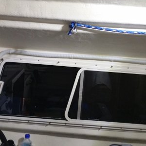 I was able to use the existing white cable run above the window covering the RADAR cable and make the house bank connection behind the helm