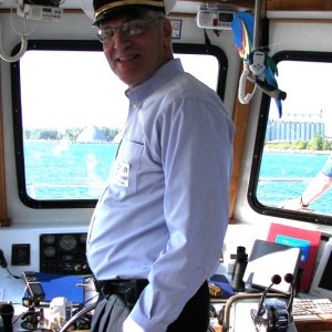 Larry K at the helm of the Huron Lady II