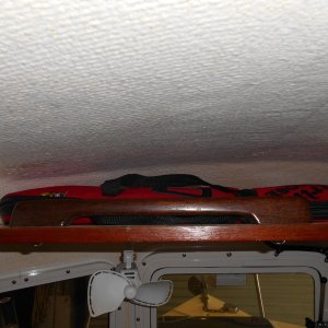 I used an old grab rail from a previous boat, to keep things from tumbling off the upper shelf.