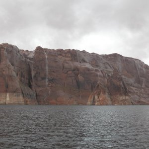 Media 'A cloud burst a few minute later produced waterfalls.  That is Hole-in-the-rock to the left.  C Swell and Cat Claw were a couple miles away and had no rain.' in album 'Time for a quick swim in Mountain Sheep Canyon.'