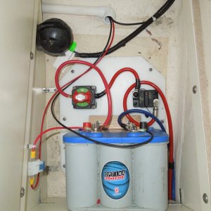 House battery installed by one the previous owners, re-installed to my standers; in forward passenger foot locker storage compartment.