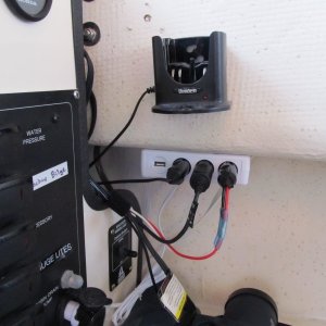 VHF charging cradle and 12v accessory sockets next to the helm.  There is one over on the co-pilot side as well.