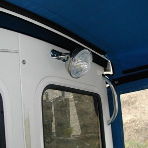 Media '(rogerbum) 3000 candlepower spreader light.  Mounted off center to 1) avoid collisions with head and 2) allow it to shine over my shoulder while cutting bait.' in album '(rogerbum) Factory upgrade of fuel covers'