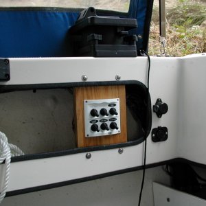 Media '(rogerbum) 6 switch electrical panel in cockpit.  Top L is Man Fore Bilge, Top C is Man Aft Bilge, Top R is Auto Aft Bilge, Bottom L is cockpit lighting (12V rope light to be installed), bottom C is SpotLight, bottom R is new 12V outlet (to right of panel, below downrigger power)' in album '(rogerbum) Factory upgrade of fuel covers'