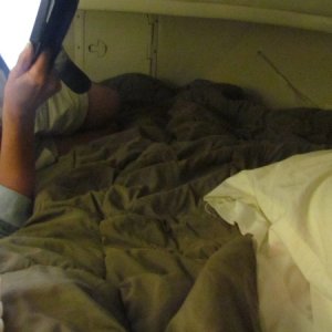 Bunk showing my side added two four inch memory foam with egg carton type sides facing each other made a separate canvas bag for the memory foam set up,sleep on top of a Travasak use light quilt to cover up with finally a comfortable berth. Anchor locker hatch in the middle of the picture