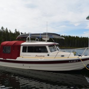 Media 'The kayak weighs a total of 32 pounds, spread between the rack and radar dome.  The bow section rests on the radar dome but does not touch the anchor light or VHF antenna.' in album 'The rack is desined to keep the kayak parallel to the boat.  By doing so the stern does not wear on the bimini, nor does the kayak act like a parachute and catch the wind.'