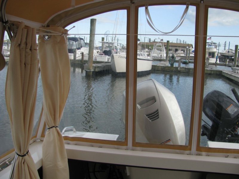 07 Marinaut 215 cockpit temporary portable toilet enclosure folded up curtains starboard side.  Please notice that the folded up curtains do not obstruct our view.