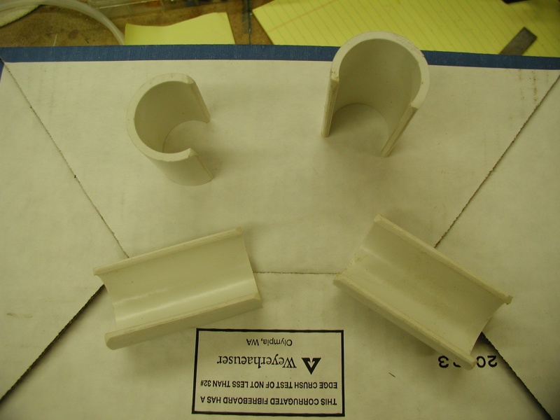 1.25" ID PVC pipe, 3/8 of diameter is cut away on table saw.  Edges rounded off to protect towels, etc.