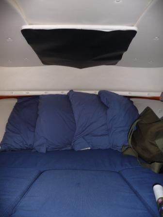 12.  Black canvas sign material cut to size and attached with "Velcro" to darken sleeping area in the day light and give better privacy at night with the light on, when tied next to a dock.