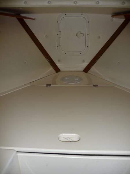 1st - a large forward "V" shaped storage locker. 
2nd - 6" round access hatch to the inside of the stem and under the anchor locker. This hatch gives clear access down under the "V" storage locker and under the cabin sole to the cabin 6" access access hatch at the inside of the door bulkhead.
3rd - Rectangular Hatch cover opens to the anchor locker.
