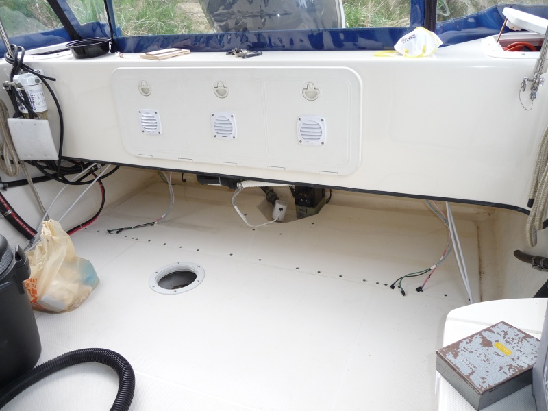 2. I used a 3/8" drill bit to drill through the top of the cockpit deck fiberglass down through the dark grey foam core to touch the bottom layer of the laminated deck. I then took a "Dremel" and hollowed out a greater amount of foam core below the top deck layer of fiberglass to give a greater area to fill in with epoxy.