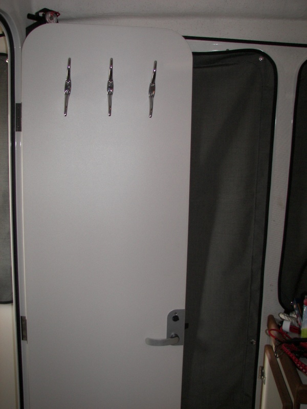 4 inch hooks, "cleats", mounted on both sides of head door. The holes started out straight on the outside, but some drifted a bit... arrgh.  Very handy for hanging things or shock cording things to.