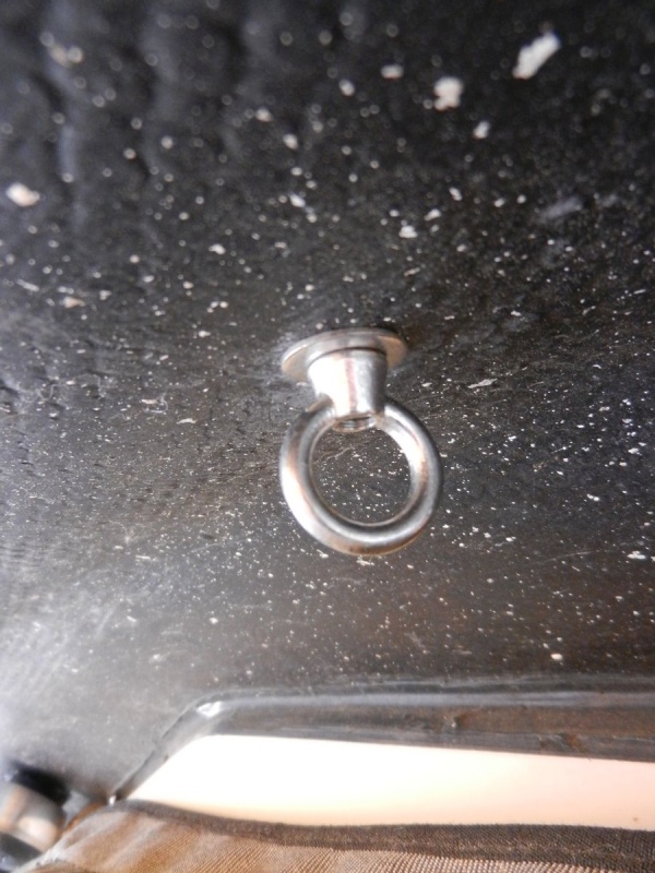 A 1/2" SS carriage bolt, e.g., http://www.mcmaster.com/#93180a208/=pbow9t and a matching eye nut, e.g., http://www.reddenmarine.com/sea-dog-078106-stainless-steel-eye-nut-1-  4.html were used.  I cut a square hole in the fiberglass to match the carriage bolt shoulder.