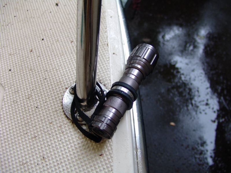 A 1" rubber covered stainless clamp from West Marine holds them in place using an existing bolt. The supplied lanyard hangs on as well in case something breaks.