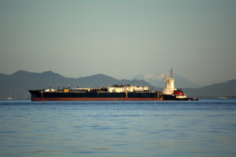 A tanker barge and tug at the refinery