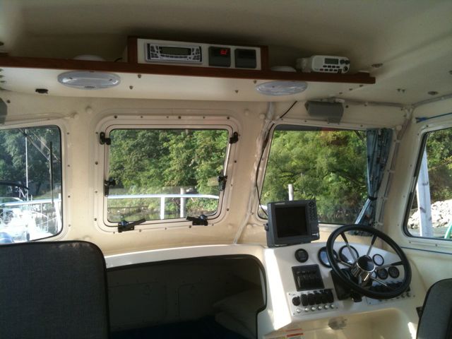 A view of the helm and electronics shelf. The two meters adjacent to the stereo are Blue Sea volt/ammeters wired directly to the batteries.
