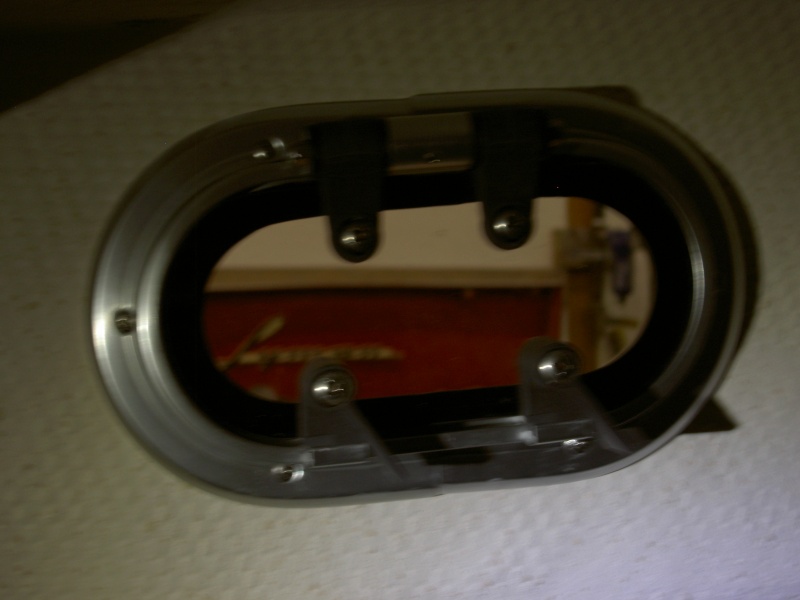 Add trim ring and secure with screws that cause the porthole to clamp to the trim ring.  Screws are not provided.