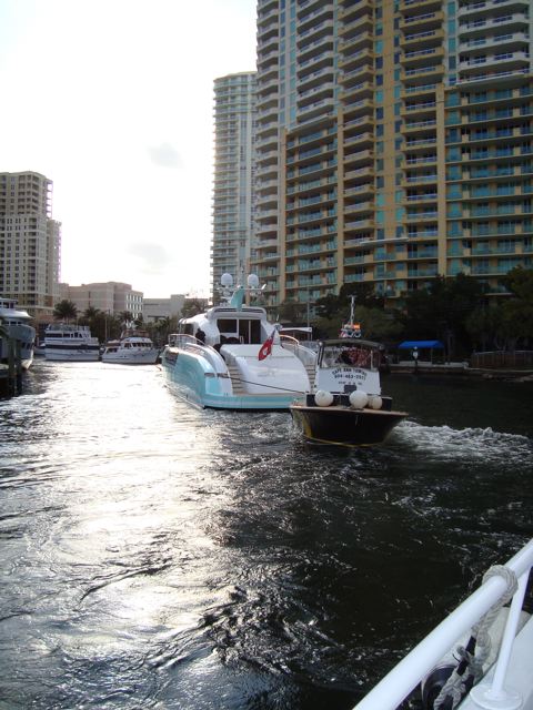 Aft view of Retro boat under tow through river. Big boats frequently use tugs for liability reasons.