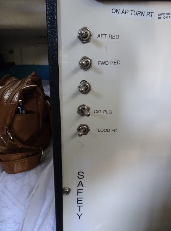 Auto pilot with two switches above, Toggle switches can be reached from the bunk and turn on red lights, the Sirius (Cig plug and a flood light which illuminates the foredeck and for docking.