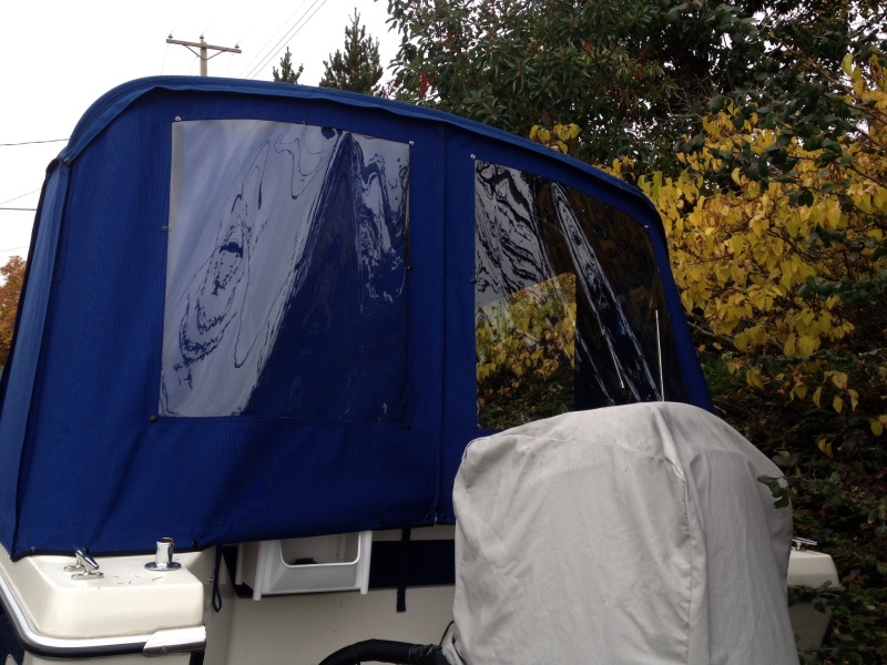 Back window port side has snap on cover, snaps on bows inside will take shower curtain for potty privacy